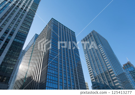 Skyscrapers towering over the blue sky Skyscrapers towering over the blue sky 125413277