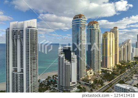 Expensive highrise hotels and condos on Atlantic ocean shore in Sunny Isles Beach city. American tourism infrastructure in southern Florida 125413418