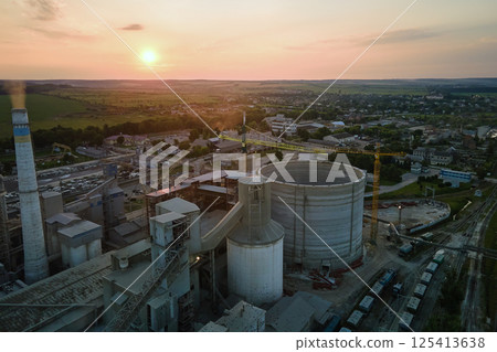 Cement plant with high factory structure and tower cranes at industrial production area. Manufacture, global industry and air pollution concept 125413638
