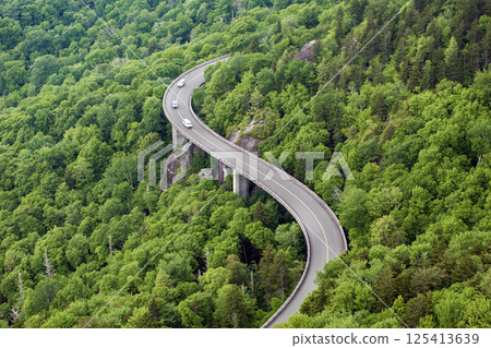 Car road trip on Blue Ridge Parkway in North Carolina. Linn Cove Viaduct in Appalachian mountains in summer rain season. Summertime landscape of beautiful nature Car road trip on Blue Ridge Parkway in North Carolina. Linn Cove Viaduct in Appalachian mountains in summer rain season. Summertime landscape of beautiful nature 125413639