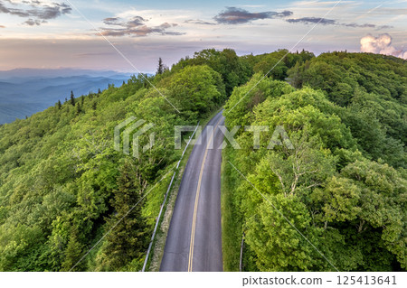 Car road trip on Blue Ridge Parkway in North Carolina Appalachian mountains in summer season at sunset. Summertime landscape of beautiful nature 125413641