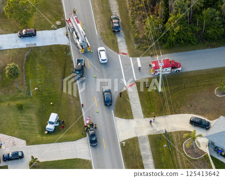 Car hit cyclist accident on city street in Florida. Result of distracted driving and speeding. Emergency paramedics at vehicle and bike crash in USA 125413642
