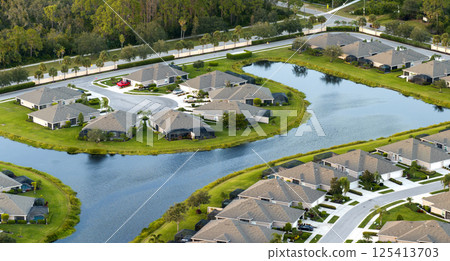 American gated community houses in rural US suburbs. View from above of large residential homes in small town in southwest Florida American gated community houses in rural US suburbs. View from above of large residential homes in small town in southwest Florida 125413703