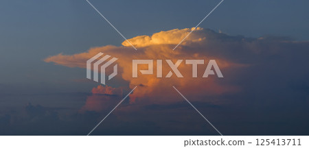 Amazing sunset skyscape. Evening sky with bright colorful orange and yellow clouds 125413711
