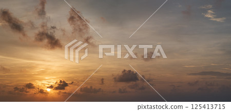 Amazing sunset skyscape. Evening sky with bright colorful orange and yellow clouds Amazing sunset skyscape. Evening sky with bright colorful orange and yellow clouds 125413715