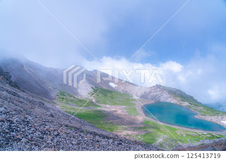 [Pond in the Sky] Mt. Norikura's Gongen Pond in the misty summer [Nagano Prefecture] 125413719