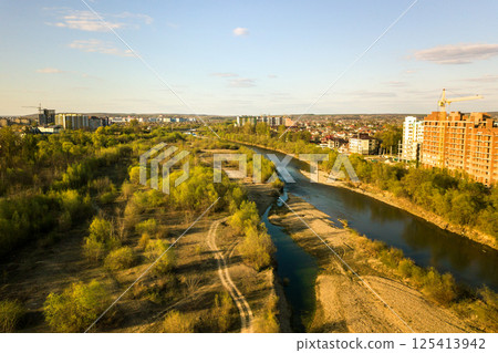 Aerial view of tall residential apartment buildings under construction and Bystrytsia river in Ivano-Frankivsk city, Ukraine. Aerial view of tall residential apartment buildings under construction and Bystrytsia river in Ivano-Frankivsk city, Ukraine. 125413942
