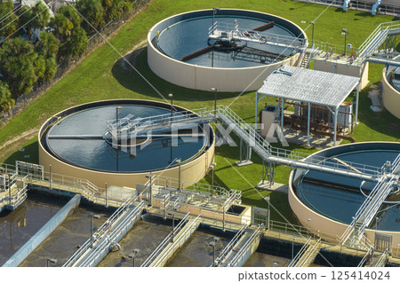 Aerial view of modern water cleaning facility at urban wastewater treatment plant. Purification process of removing undesirable chemicals, suspended solids and gases from contaminated liquid Aerial view of modern water cleaning facility at urban wastewater treatment plant. Purification process of removing undesirable chemicals, suspended solids and gases from contaminated liquid 125414024