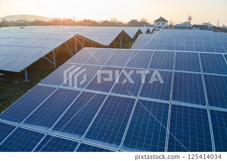 Aerial view of large sustainable electrical power plant with rows of solar photovoltaic panels for producing clean ecological electric energy. Renewable electricity with zero emission concept. Aerial view of large sustainable electrical power plant with rows of solar photovoltaic panels for producing clean ecological electric energy. Renewable electricity with zero emission concept. 125414034