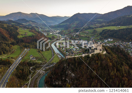 Aerial view of green meadows with villages and forest in austrian Alps mountains. Aerial view of green meadows with villages and forest in austrian Alps mountains. 125414061