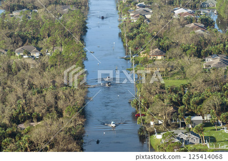 Aerial view of flooded street after hurricane rainfall with driving cars in Florida residential area. Consequences of natural disaster Aerial view of flooded street after hurricane rainfall with driving cars in Florida residential area. Consequences of natural disaster 125414068