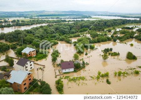 Aerial view of flooded houses with dirty water of Dnister river in Halych town, western Ukraine. Aerial view of flooded houses with dirty water of Dnister river in Halych town, western Ukraine. 125414072