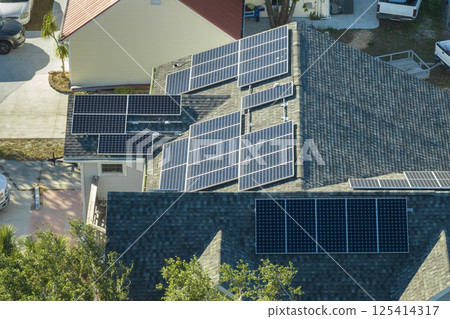 Aerial view of american building roof with blue solar photovoltaic panels for producing clean ecological electric energy. Investing in renewable electricity for retirement income concept 125414317