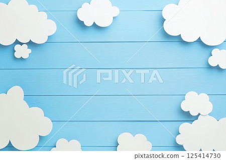 The fluffy clouds appear as paper on a serene blue wooden background 125414730