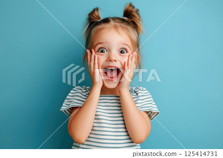 A little girl is making a very surprised face with her mouth open wide 125414731