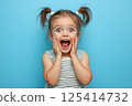 A little girl is making a very surprised face with her mouth open wide 125414732