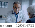 A doctor is engaged in a conversation with a patient in a hospital setting 125414733