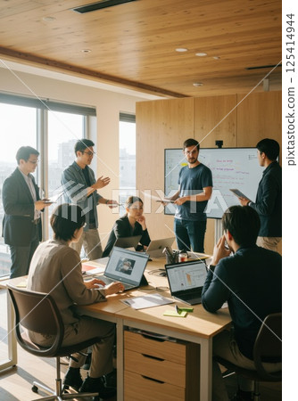 Modern office of Japanese team working together using devices (AI generated image) Modern office of Japanese team working together using devices (AI generated image) 125414944