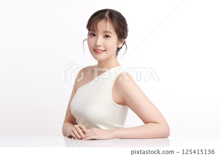 A beautiful young Asian woman with clean, fresh skin against a white background. Skincare, facial treatment, cosmetology, beauty, and spa. An elegant portrait of an Asian woman. A beautiful young Asian woman with clean, fresh skin against a white background. Skincare, facial treatment, cosmetology, beauty, and spa. An elegant portrait of an Asian woman. 125415136