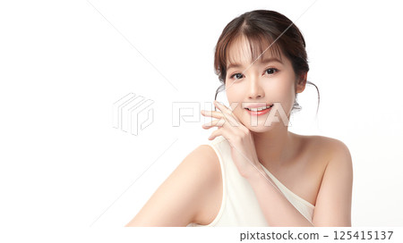 A beautiful young Asian woman with clean, fresh skin against a white background. Skincare, facial treatment, cosmetology, beauty, and spa. An elegant portrait of an Asian woman. 125415137