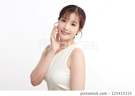 A beautiful young Asian woman with clean, fresh skin against a white background. Skincare, facial treatment, cosmetology, beauty, and spa. An elegant portrait of an Asian woman. A beautiful young Asian woman with clean, fresh skin against a white background. Skincare, facial treatment, cosmetology, beauty, and spa. An elegant portrait of an Asian woman. 125415155