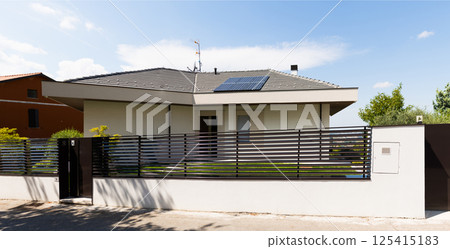 House with white roof and solar panel on top House with white roof and solar panel on top 125415183