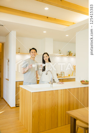 A couple standing in the kitchen A couple standing in the kitchen 125415383