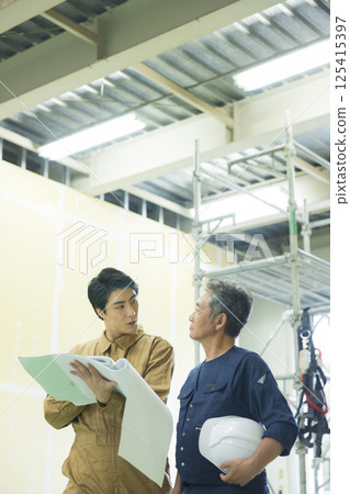 Site supervisors discussing plans at the site Site supervisors discussing plans at the site 125415397