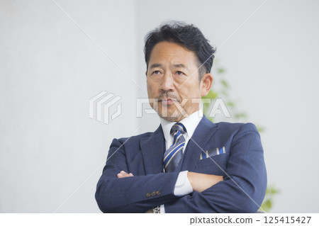 A businessman sitting in a chair 125415427