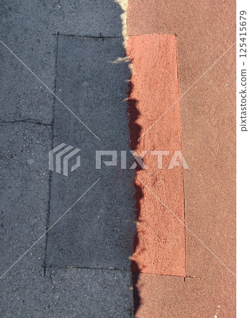 pavement repair with contrasting color section along city sidewalk during daylight hours. pavement repair with contrasting color section along city sidewalk during daylight hours. 125415679