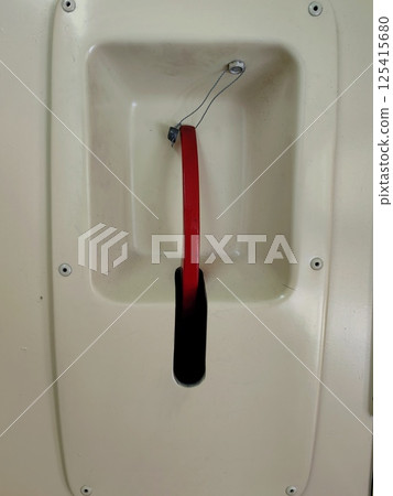 emergency brake handle located inside vehicle for quick stopping action in urgent situations. emergency brake handle located inside vehicle for quick stopping action in urgent situations. 125415680