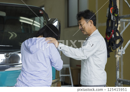 A couple who run a construction company standing in front of a truck 125415951