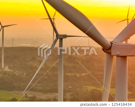 Wind farm field and sunset sky. Wind power. Sustainable, renewable energy. Wind turbines generate electricity. Sustainable development. Green technology for energy sustainability. Eco-friendly energy. 125416434