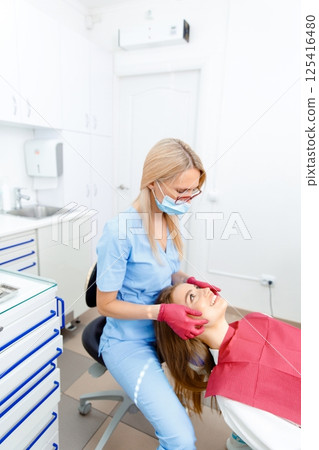 generous facial joints, osteopath performs, facial massage joints, checking teeth, oral care, healthy teeth, Dental treatment generous facial joints, osteopath performs, facial massage joints, checking teeth, oral care, healthy teeth, Dental treatment 125416480
