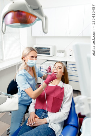 teeth whitening, dentist checking teeth, dental examination, patient's teeth, hospital office, ensuring dental health teeth whitening, dentist checking teeth, dental examination, patient's teeth, hospital office, ensuring dental health 125416487