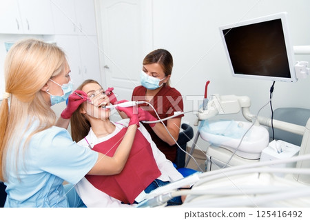 dental examination, dental health, checking teeth, hospital office, smiling patient, dentistry clinic, dental chair, consultation 125416492