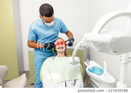 whitening procedure, Dentist starting teeth, receiving teeth cleaning, treating teeth, professional doctor fixing teeth, Dentist checking, patient dentist clinic whitening procedure, Dentist starting teeth, receiving teeth cleaning, treating teeth, professional doctor fixing teeth, Dentist checking, patient dentist clinic 125416506