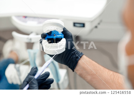Dental treatment, Dentist checking teeth, dental examination, smiling woman, dental procedure, treating teeth, female at a dental clinic smiling 125416558