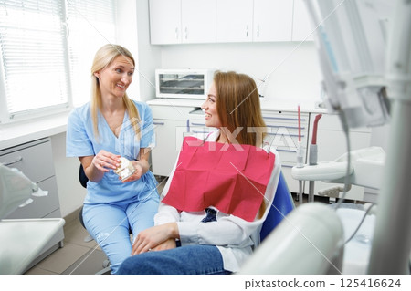 dental procedure, patient lying, dentist checking teeth, smiling patient, hospital office, oral care, dental health 125416624