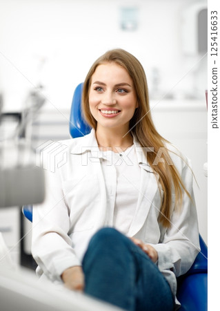 smiling dentist patient, dental chair, dentist patient, dentistry clinic, dental procedure, Smiling dentist communicating, dental instruments smiling dentist patient, dental chair, dentist patient, dentistry clinic, dental procedure, Smiling dentist communicating, dental instruments 125416633