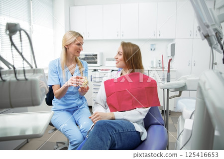 dental procedure, patient lying, dentist checking teeth, smiling patient, hospital office, oral care, dental health 125416653