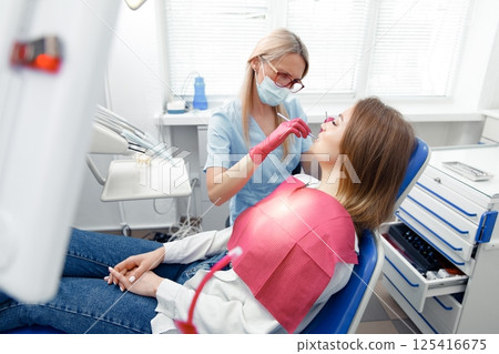 teeth whitening, dentist checking teeth, dental examination, patient's teeth, hospital office, ensuring dental health 125416675