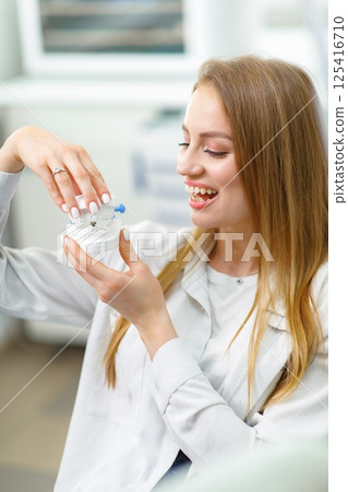 dental care, smiling woman dentistry, dental examination, orthodontic clinic, young female, visiting doctor, beautiful woman, 125416710