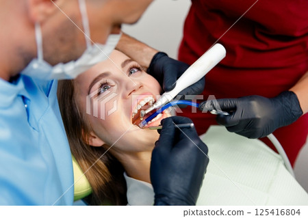dental procedure, dentist chair, Dental treatment, Young lady lying, female patient, Dentist examining, treating teeth, dental procedure, dentist chair, Dental treatment, Young lady lying, female patient, Dentist examining, treating teeth, 125416804