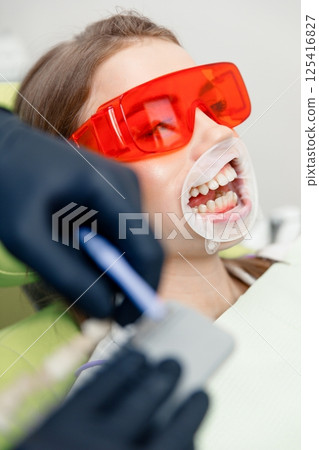 whitening procedure, Dentist starting teeth, receiving teeth cleaning, treating teeth, professional doctor fixing teeth, Dentist checking, patient dentist clinic 125416827