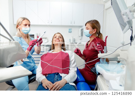 dental procedure, patient lying, dentist checking teeth, smiling patient, hospital office, oral care, dental health 125416890