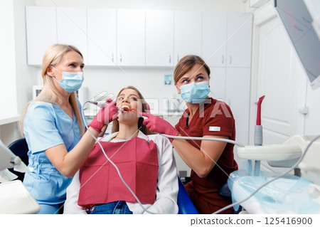 dental procedure, patient lying, dentist checking teeth, smiling patient, hospital office, oral care, dental health dental procedure, patient lying, dentist checking teeth, smiling patient, hospital office, oral care, dental health 125416900
