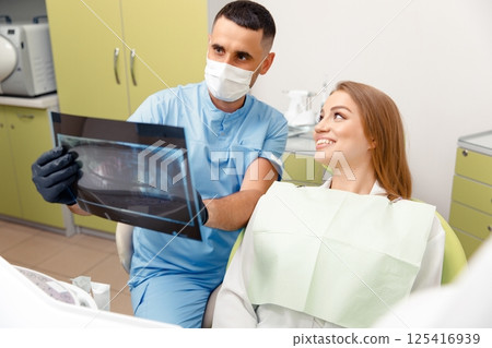 panoramic X-ray, dental consultation, dentistry clinic, dental inspection, dentist tells the patient, treating teeth, smiling patient 125416939