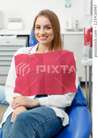 smiling dentist patient, dental chair, dentist patient, dentistry clinic, dental procedure, Smiling dentist communicating, dental instruments smiling dentist patient, dental chair, dentist patient, dentistry clinic, dental procedure, Smiling dentist communicating, dental instruments 125416947