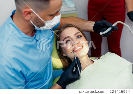 dental procedure, dentist chair, Dental treatment, smiling patient, female patient, Dentist examining, treating teeth, dental procedure, dentist chair, Dental treatment, smiling patient, female patient, Dentist examining, treating teeth, 125416954